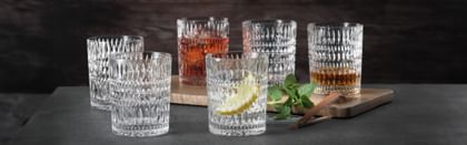 Six NACHTMANN Ethno tumblers in front of a black background, three of them filled with different beverages
