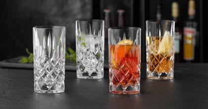NACHTMANN Noblesse longdrink glasses, three of them filled with cocktail drinks on ice and one is empty.<br/>